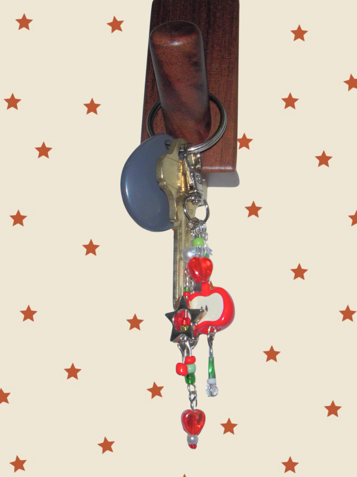 Keychain with charms against a colorful background featuring cartoon characters and a moon.
