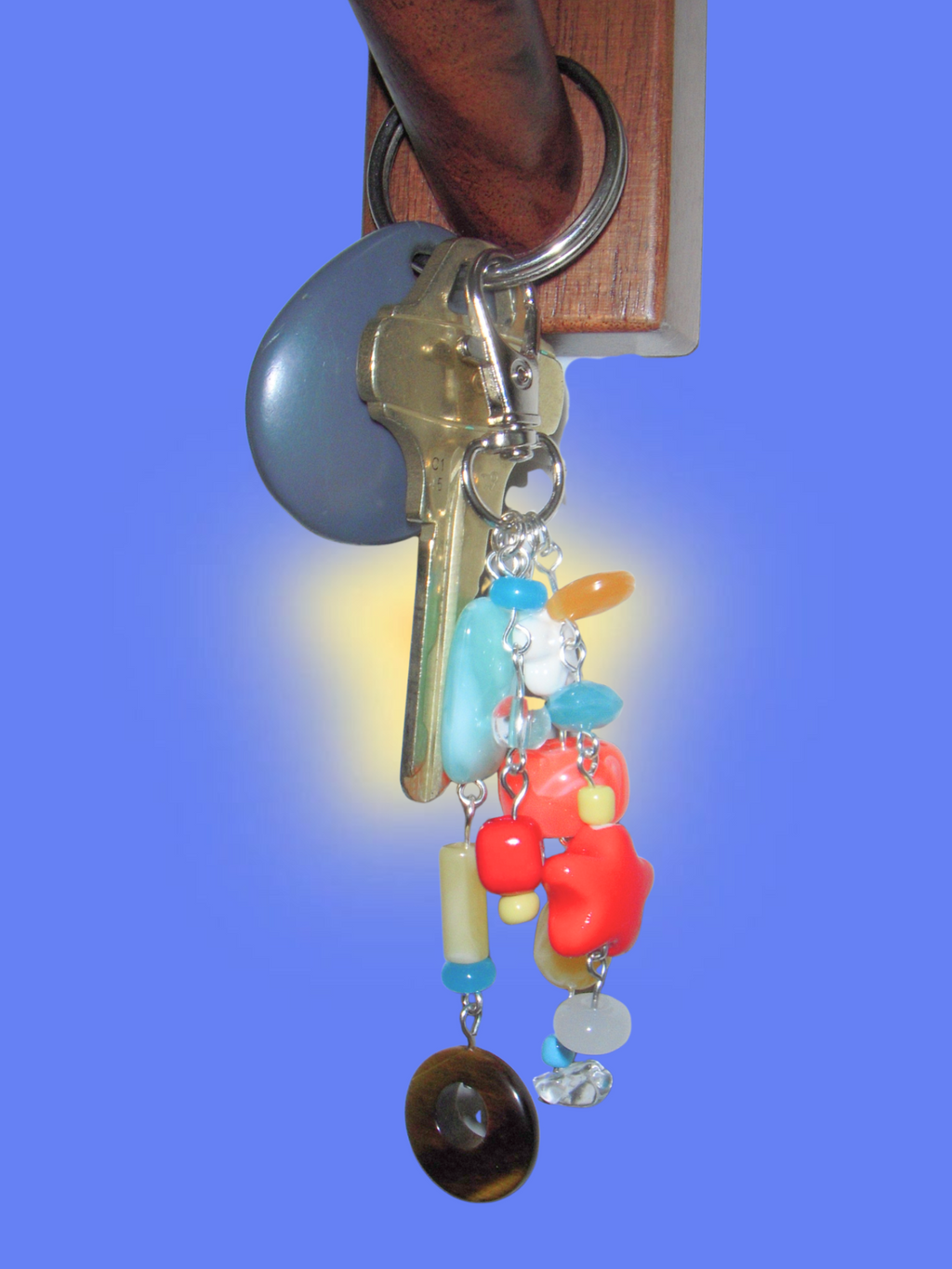 Keychain with colorful beads and keys on a blue background