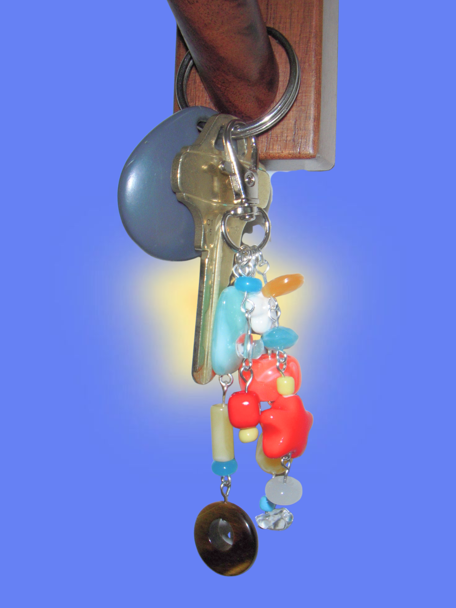 Keychain with colorful beads and keys on a blue background