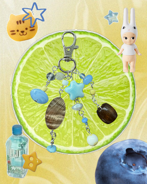Keychain with star and shell charms on a lime slice background